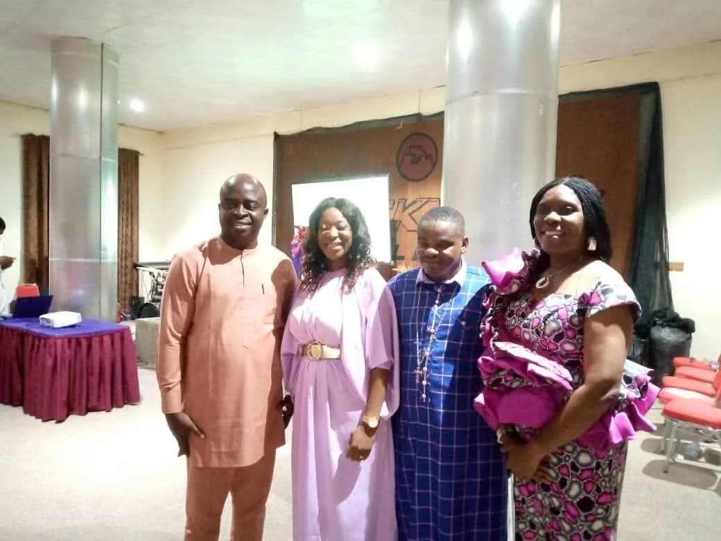 Four guests standing together in the conference hall after the session
