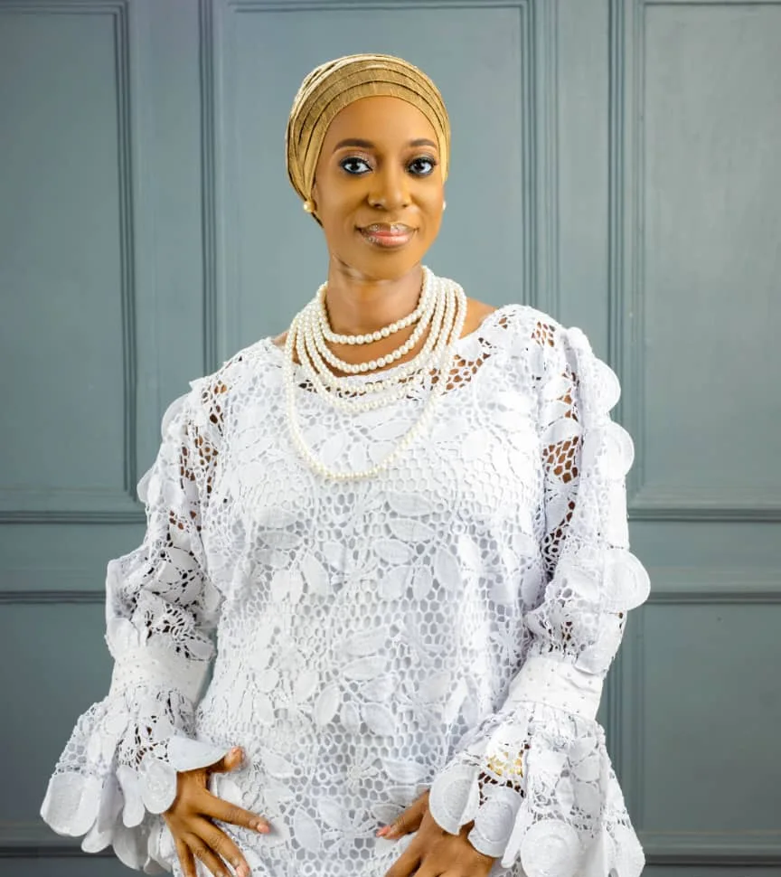 Apostle Ogochukwu Yvonne Ukwu, Convener of The Derushah Global Network Ministry, in white lace and a gold head-tie