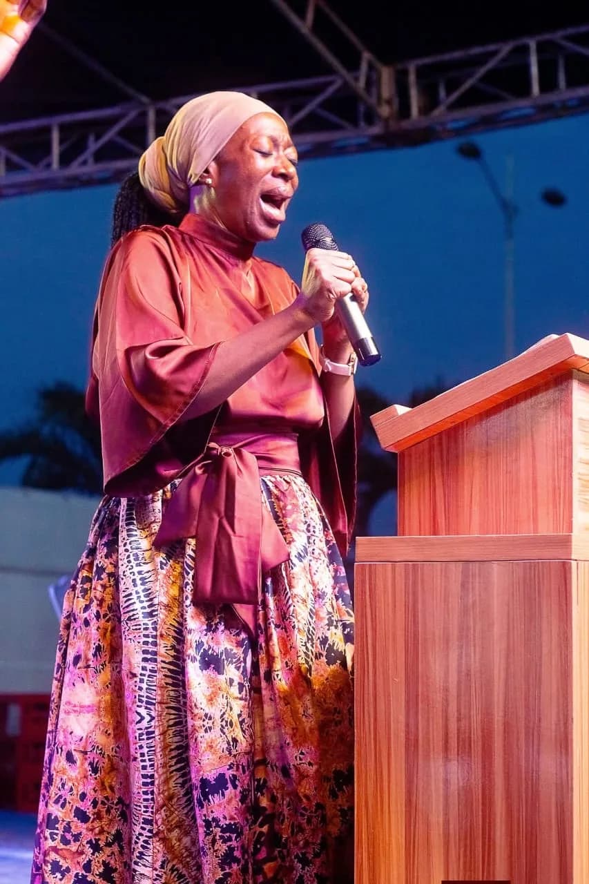 A minister leading prayer at the lectern during an evening prayer summit